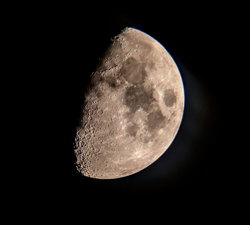 A sharp telescope image of the moon showing crater detail