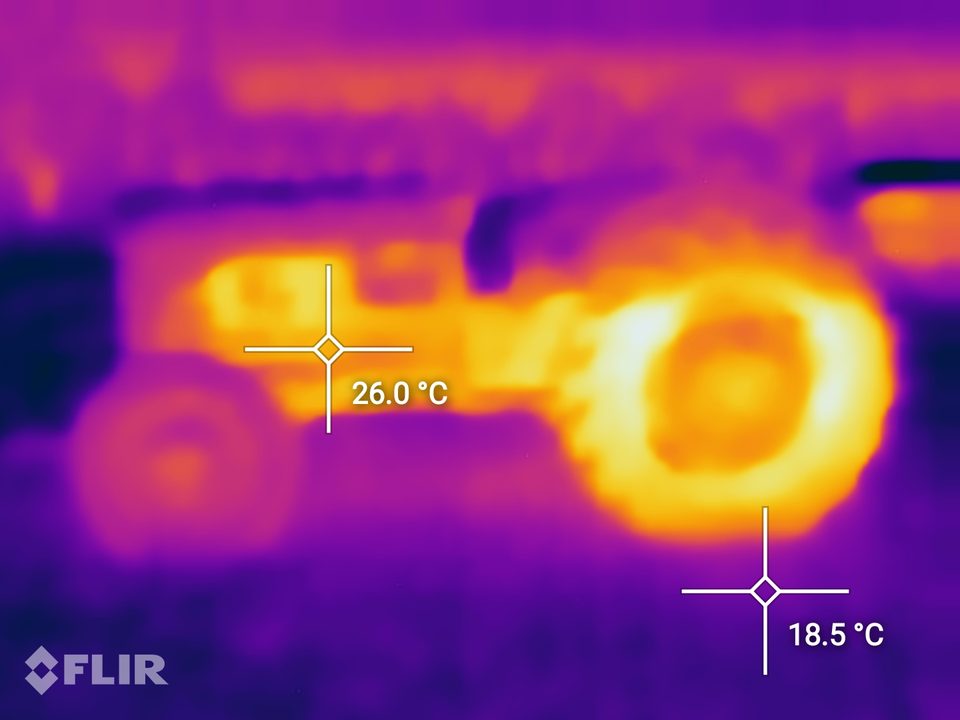 A thermal camera image of a tractor showing its rear tyre glowing hot